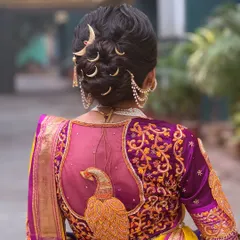 A closer view of the Maharashtrian bridal bun, showing the precise placement of the moon-shaped 'chandrakor' pins that are central to this traditional look.