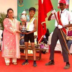 A proud moment as Irvin receives his championship trophy at the school's annual athletic meet.
