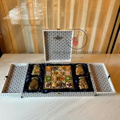 A sophisticated black and white patterned gift box that exudes modern luxury. This hamper is filled with four jars of premium nuts and a delicious assortment of our handcrafted sweets, making it an ideal corporate gift.
