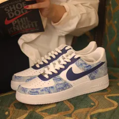 Reading "Shoe Dog" by Nike's founder, Phil Knight, with my custom Dior-inspired Nikes. It feels like the perfect combination of sneaker history and high-fashion art.