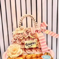 A handbag cake designed for Women's Day, featuring delicate pink frosting rosettes and a pearl handle. It's a sweet tribute to the strength and style of women everywhere.