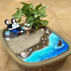 A closer look at a beach-themed miniature garden. I use real sand, tiny hand-sculpted accessories, and live plants to create these tranquil scenes.