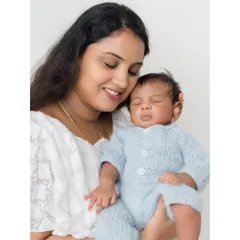 A mother's warm embrace. The soft smile on this new mom's face as she holds her baby close shows the incredible love of motherhood.