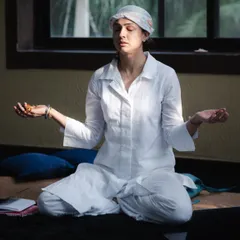 A moment of deep meditation during a workshop. Dressed in white to reflect the light, with a head covering to focus my energy, I find my center before holding space for others.