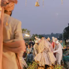 The groom watches as his bride makes her grand entrance, carried on a doli. We capture the anticipation and emotion from both perspectives.