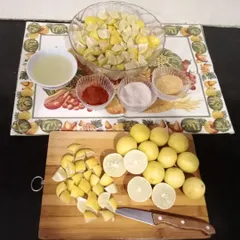 The process of making lemon pickle begins with cutting fresh lemons and mixing them with our special spice blend. It's all done by hand.