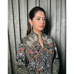 A chic and modern look for an evening event. The sleek ponytail and clean makeup are sophisticated, while the intricate black outfit adds a touch of drama.
