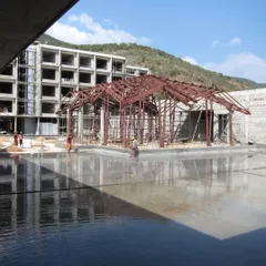 The steel skeleton of the Lotus Cafe during construction, revealing the complex engineering required to achieve its light, floating form.