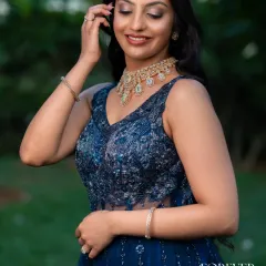 A close-up of the blue katdana corset gown. The sheer waist panel and the intricate beadwork on the bodice create a look that is both alluring and sophisticated, perfect for an evening celebration.