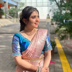 A beautiful outdoor shot of Payal. The natural light highlights the dewy finish of her skin and the soft colors of her makeup.