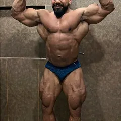 The front double bicep is a mandatory pose that wins shows. Here, I'm 48 days out from a competition, checking my progress with my Guruji. We track every detail to ensure we're on target.