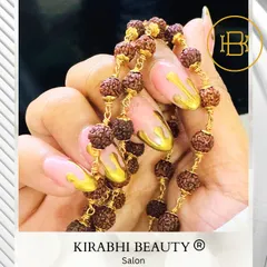 Another creative shot of the gold drip nails, showing how they can accessorize and complement your jewelry.