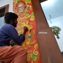 Here I am, working on a pooja room wall, painting a mural of Unnikannan and Ganesha. Painting directly on the wall integrates the art into the architecture of the home itself.