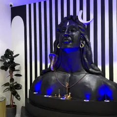 A side view of the completed Adiyogi installation, showing how it integrates with the reception area. The lighting creates a divine aura, making the space feel both welcoming and reverent.