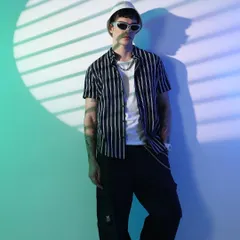 Cyberpunk visions for Highlander. I used striped lighting effects and a cool color palette to create this futuristic look, styling a simple striped shirt with a bucket hat and modern sunglasses.