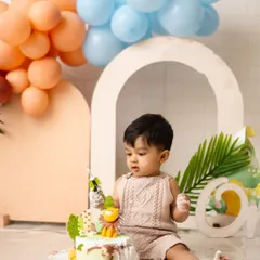 This little one is carefully inspecting his jungle-themed birthday cake before the big smash. The anticipation is just as cute as the event itself.
