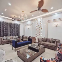 The main living area of Villa 9/21B combines classic elegance with modern touches. We used a mix of plush upholstery, metallic accents, and custom lighting fixtures like the crystal chandelier to create a luxurious and inviting atmosphere.