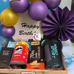 Another view of our popular birthday hamper for him, showing the arrangement of the sports shaker, snacks, and decorative elements in a wooden tray.