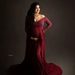 A classic, elegant pose in a deep red, off-the-shoulder gown that drapes beautifully.