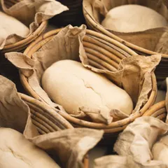 After shaping, the dough rests in banneton baskets. This proofing stage is crucial for developing the sourdough's complex flavor and signature open crumb.