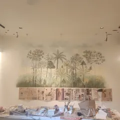 The mural in progress. This behind-the-scenes shot shows the dining area protected by newspaper as the artwork takes shape, revealing the messy but beautiful process of creation.