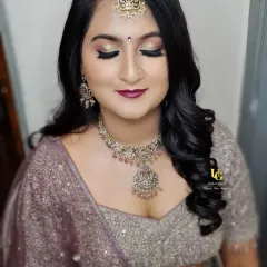This reception look features a glittery smokey eye and a deep berry lip. I teach techniques for creating these popular party styles, including how to make your makeup last all night.