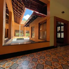The transition from the covered veranda to the open courtyard, demonstrating how these traditional homes seamlessly blend indoor and outdoor living.