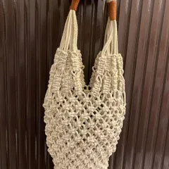 This is my full macrame net-style tote bag, a perfect companion for a trip to the market. It's lightweight, expandable, and has sturdy, comfortable handles.