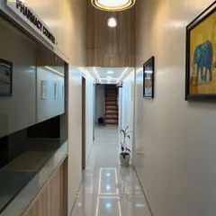 A view of the main corridor leading to the consultation and procedure rooms. The clinic is designed with clean lines and a professional aesthetic to ensure you feel comfortable and confident in our care.
