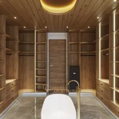 A direct view of the open-concept bathroom and wardrobe, showcasing the seamless integration of spaces. The oval ceiling light mirrors the shape of the tub, creating a harmonious design.