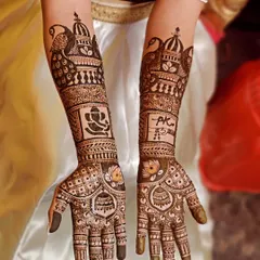 This bridal mehendi is full of personal touches. It includes a Ganesha for blessings, the couple's initials 'PK', and traditional doli and peacock motifs.