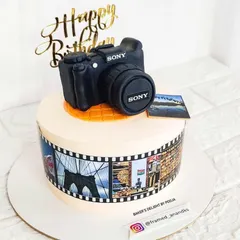 A special creation for a photography enthusiast. This cake features a hand-sculpted, realistic Sony camera topper and an edible film strip around the side showcasing the photographer's own beautiful pictures.