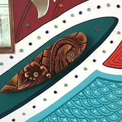 Another detail shot of the abstract entrance mural, highlighting a carved, wooden-textured 3D element surrounded by painted patterns and decorative gems. We love combining different materials in our work.