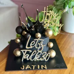 Celebrating 30 in style with this stunning black and gold birthday cake. The design features a dramatic black splash effect, gold spheres, and a sparkling "Let's Talk 30" topper.