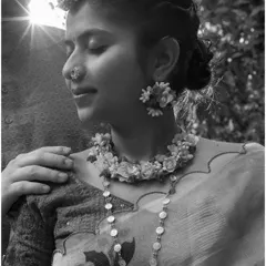 A serene black and white portrait from a Haldi ceremony. The sunlight filtering through the trees adds a magical touch to this quiet, intimate moment.