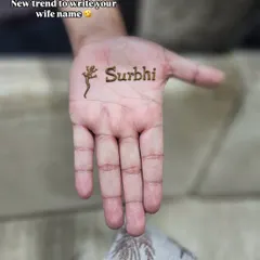 A fun and simple way to include your wife's name in your mehndi. This design features the name 'Surbhi' alongside a small, quirky lizard motif for a touch of personality.
