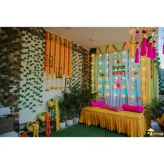 A wide shot of the vibrant and colorful decor for a home-based Mehndi and Haldi ceremony.