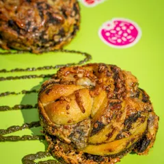 Say hello to our Pesto Cheese Braid. The pesto is made in-house with Kashmiri walnuts, braided into soft dough, and finished with good old Amul cheese.