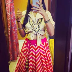 Here's a fun fusion look I put together, pairing a simple shirt with a colorful striped lehenga skirt. This is a great option for a mehendi or a casual wedding event where you want to be comfortable yet stylish.