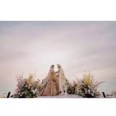 A serene beachside ceremony for Vedika and Yuvraj in Goa. The pastel sky and the gentle waves provide a tranquil and romantic setting for their vows.