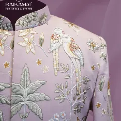 My designs often draw inspiration from nature, as seen in this pastel lavender Jodhpuri suit. The shoulder is adorned with delicate threadwork depicting a pair of birds and floral branches, showcasing a softer, more artistic side of men's ethnic couture.