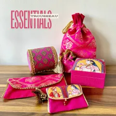 These are the essential elements of a royal trousseau. I’ve curated a set of matching rani pink items, including a bangle case, potli, and jewelry box, all featuring a classic Raja-Rani theme.
