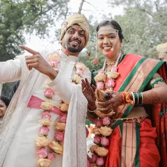 The celebration begins. This joyful, candid shot of the newly married Maharashtrian couple shows their vibrant personalities and the happiness of the moment, a perfect blend of tradition and fun.