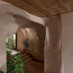 The organic, cave-like forms at Dubki were crafted from ferro-cement, with muted, earthy tones to create a warm and grounded atmosphere. The design seamlessly blends the built environment with the natural cliffside setting.