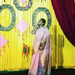 Another shot in the same saree, this time against a festive yellow backdrop with traditional decor, capturing the celebratory mood of the festival.