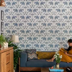 A quiet moment in the Boho-Desi lounge, perfect for reading. The vibrant wallpaper and comfortable sofa create an inspiring and relaxing corner, showcasing how our designs support everyday moments of peace.