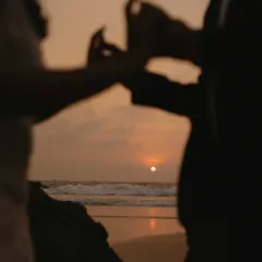 A silhouette against the setting sun. I framed this shot to capture the intimacy of the couple holding hands, with the beautiful Goan sunset creating a perfect, romantic backdrop.