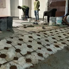 Our team at work on a residential project, installing grass pavers. This process requires precision and care to ensure a level surface and a beautiful final result.