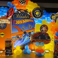 This Hot Wheels theme is perfect for young car enthusiasts. The backdrop features the iconic orange track, and we've included themed props like tires, checkered flags, and a neon sign to complete the look.