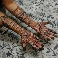 This design tells a story with personalized panels. It includes architectural jharokhas and figures that are meaningful to the bride, making her mehendi truly one of a kind.